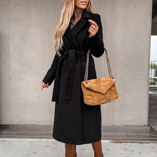 Belted long coat for women with a wide lapel collar