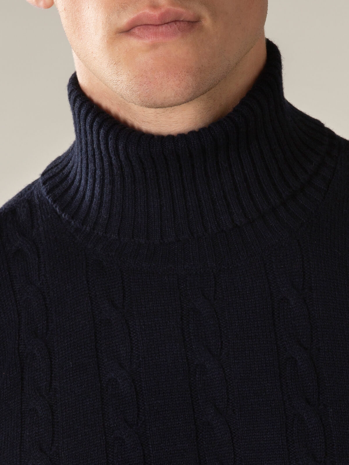 Men's cable knit turtleneck sweater with long sleeves and ribbed trim