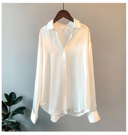 Oversized shirts for women with pointed collar, button down front and curved high low hem